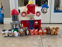 Overall view of barn playset with silo, bell and 11 figures lined in front