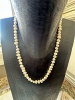 Full view of necklace displayed to show length and pearl consistency