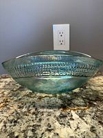 Side view showing textured exterior band and iridescent blue color