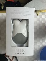 Front view of boxed NuFACE Mini device