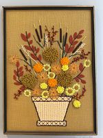 Full view of framed crewel floral artwork