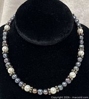 Close-up of necklace on display bust showing pearl and sterling bead pattern