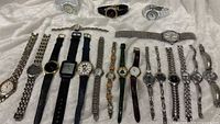 All watches laid out showing variety, approx twenty pieces