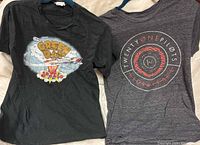 Both band T-shirts on hangers