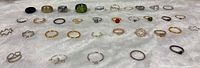 Full array of rings in four rows on white fabric