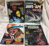 Four vintage comic magazines laid out