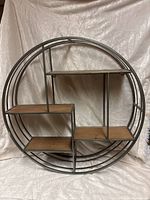 Front view of circular shelf showing frame and shelves
