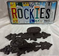 License plate art sign with two cast iron handles