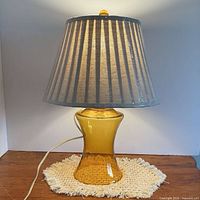 Front view of amber glass lamp with pleated shade