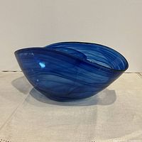 side view showing asymmetrical rim and blue swirl glass