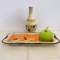 Overview showing vase, serving dish and scale reference apple