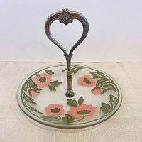 Full view of frosted glass plate with painted flowers and metal handle