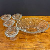 Full set showing oval bowl with four matching pedestal dishes