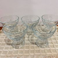 Five pressed glass dessert cups front view