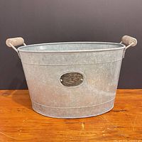 Front view showing oval shape, rolled rim, wood handles