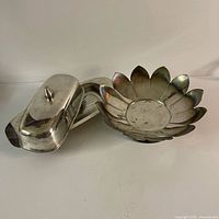 Butter dish with lid opened alongside leaf-form bowl