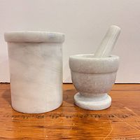 Utensil crock, mortar and pestle side by side