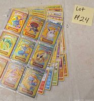 Front sleeve showing gold-foil Pokémon cards stacked with additional sleeves behind