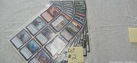 Stack of clear nine-pocket binder sleeves filled with Magic: The Gathering cards
