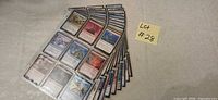 Stack of sleeved MTG cards fanned out showing black-back sleeves