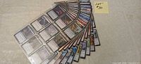 Fanned stack of sleeve pages showing numerous MTG cards