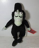 Front view of Snidely Whiplash plush showing outfit, facial features, hang tag