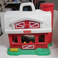Front view of Fisher-Price barn showing doors, carry handle and green base