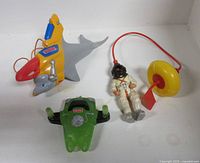 All three Fisher-Price pieces laid out: dolphin with pack, diver with float, green sled