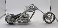 Left side view of silver die-cast chopper motorcycle model
