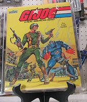 Front cover of GI Joe "The Trojan Gambit" book in plastic sleeve