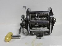 Front view of Penn Peer No.209 reel showing spool with wire line, chrome frame and yellow handle