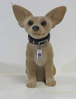 Front view of tan Taco Bell Chihuahua bobblehead with collar and logo tag