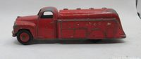 Left side view of red Dinky Toys tanker truck showing overall length and paint condition