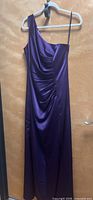 Front view of one-shoulder royal purple dress on hanger