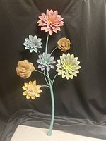 Front view showing six flower heads, mixed metal and burlap petals, teal stem