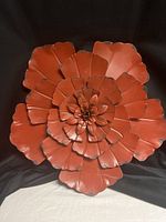 Front view of layered terracotta metal flower wall art