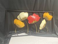 Full view of metal wall art showing five flowers in frame