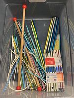 Overview of bin containing assorted straight, circular and packaged double-point needles