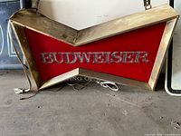 Full view of Budweiser bowtie sign showing front face, frame and power cord