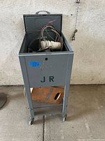 Full view of gray rolling cart standing upright