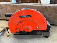 Left side view showing orange blade guard and brand label