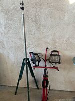 Full view showing Craftsman dual lights on red stand and separate green-leg telescopic stand