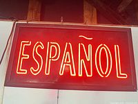 Sign illuminated showing red neon letters