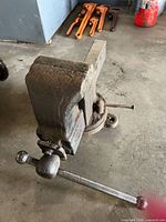Side view of cast iron bench vise showing swivel base and main screw handle