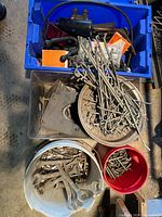 Top view of blue tote with stakes, hooks, brackets, orange package