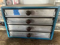 Front view of blue 4-drawer metal cabinet
