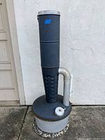 Full view of smudge pot heater showing base, vent stack, side pipe and filler cap