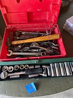 Open red toolbox and green socket case showing all hand tools included in lot