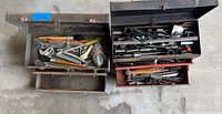 Open view of both toolboxes showing assorted hand tools inside