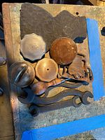 Lot overview showing various caps, wrenches, valve, wooden handle and plates